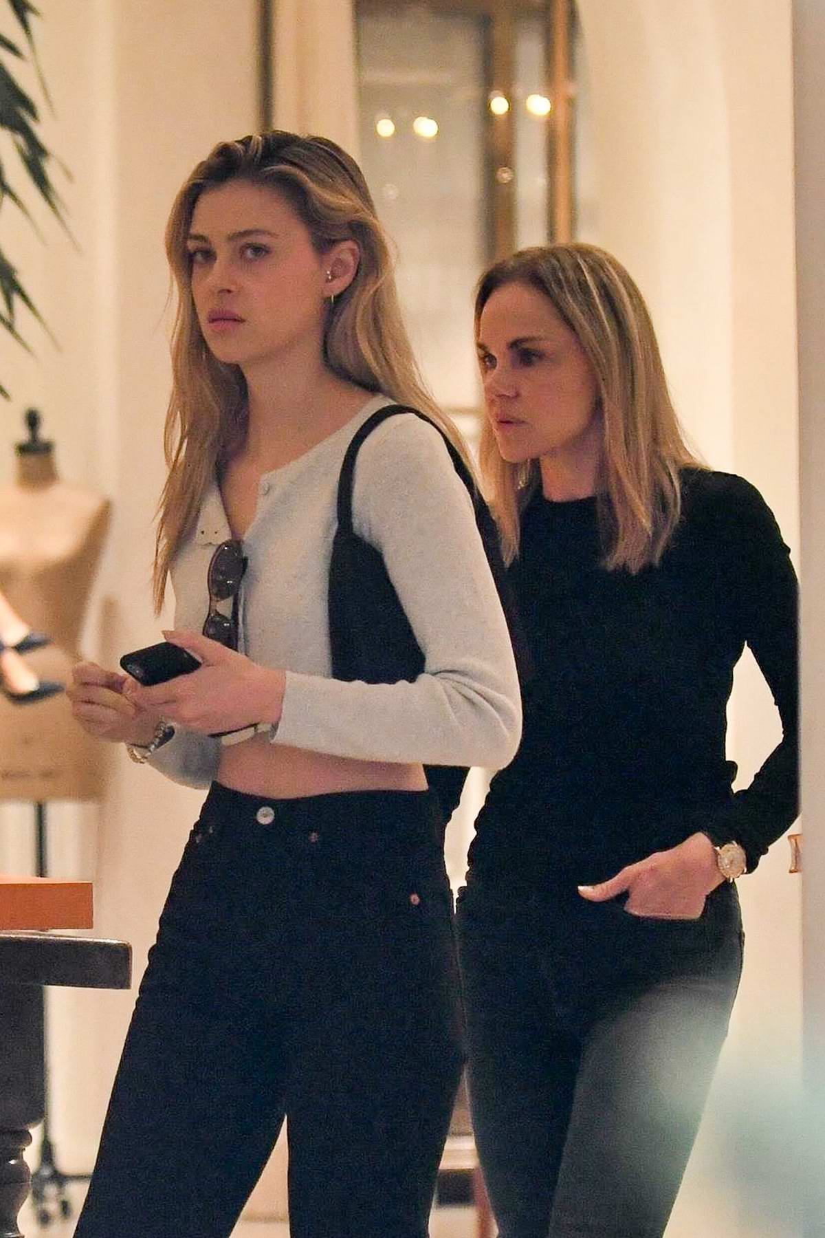 nicola peltz getting some shopping done at yves saint laurent with her