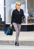 Emma Roberts seen wearing a black jacket and animal print leggings while out shopping in Studio City, California