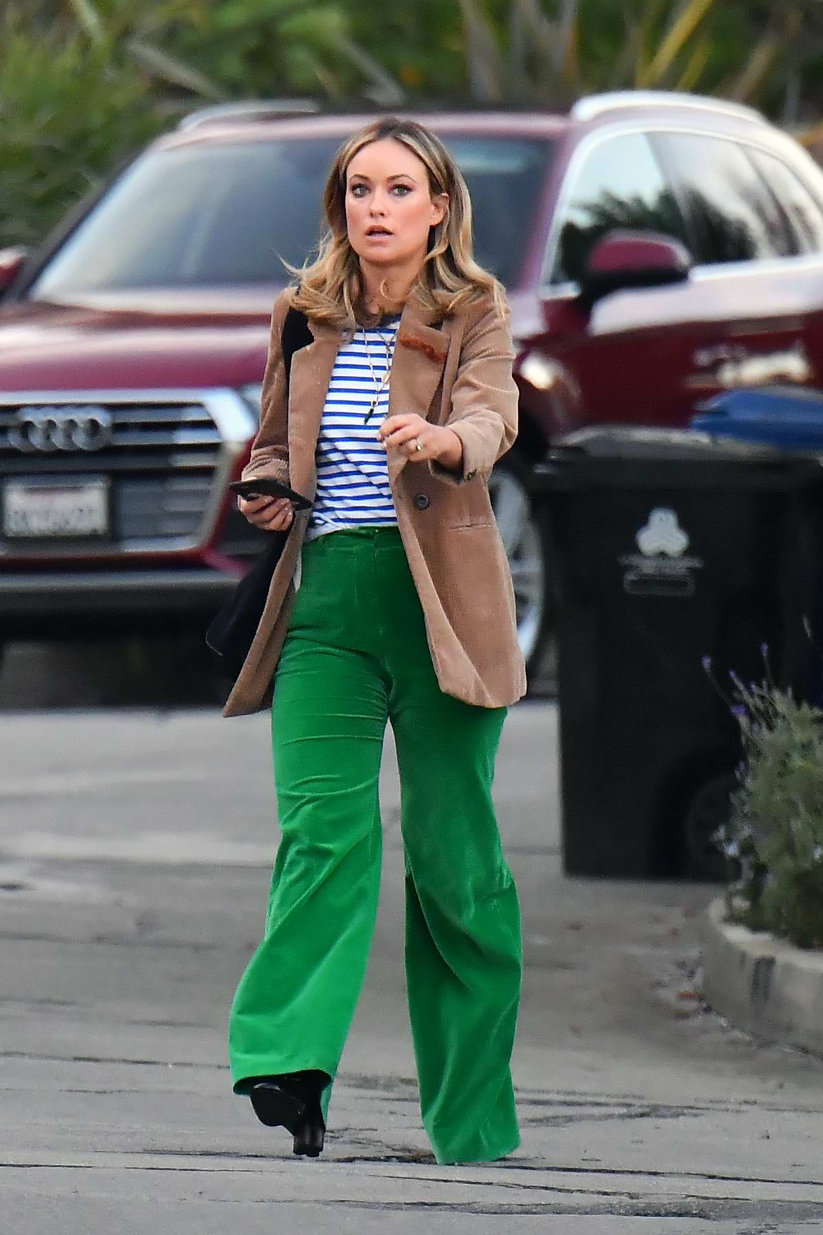 Olivia Wilde looks great in bright green pants and brown blazer as