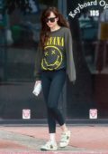 Dakota Johnson wears 'Nirvana' sweatshirt, leggings and Gucci sneakers as she leaves a yoga session in Studio City, California