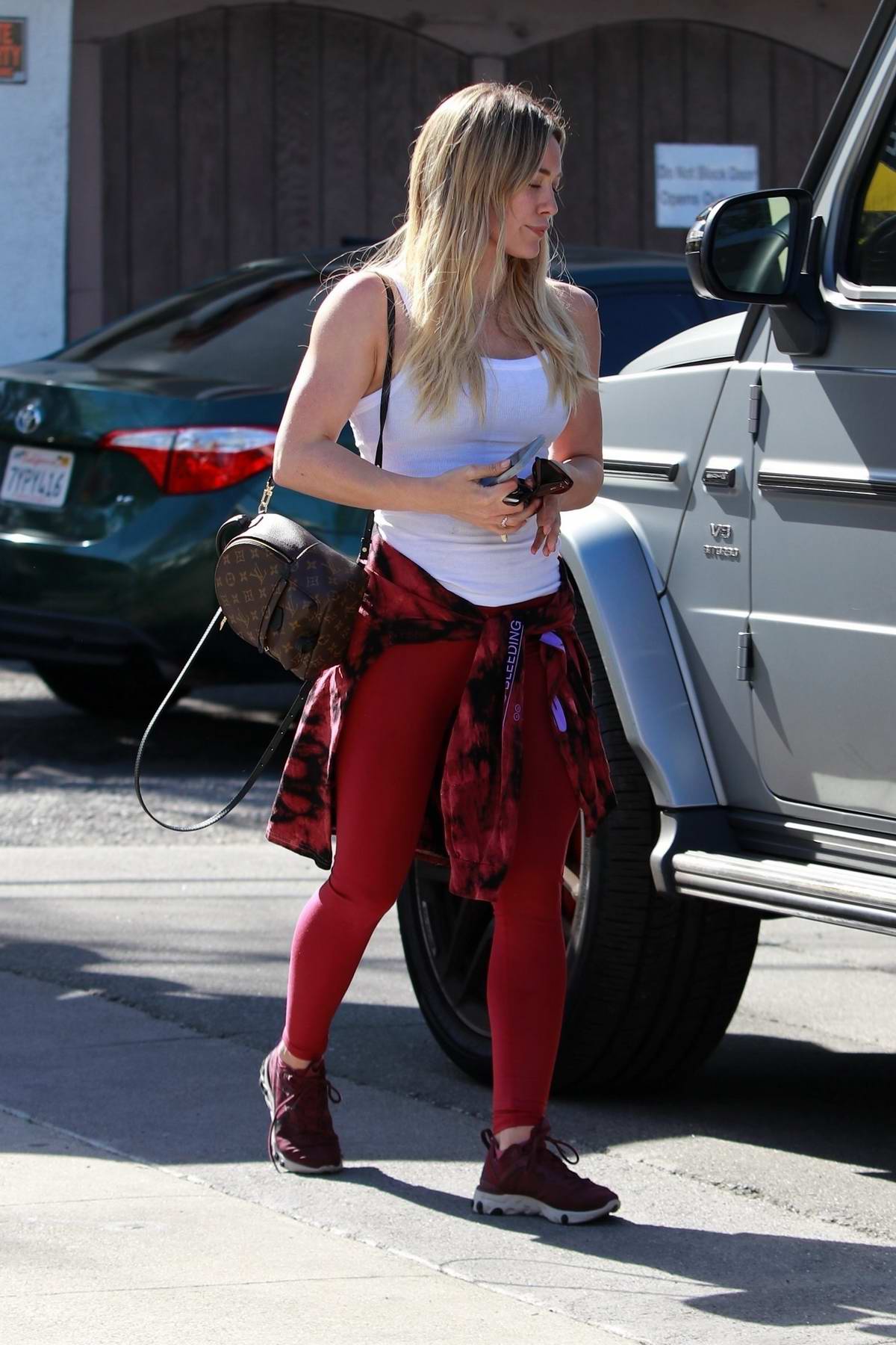 Addison Rae bares her toned midriff in a sports bra and leggings while  leaving Forma Pilates