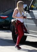 Hilary Duff looks fierce in red leggings and a white top while