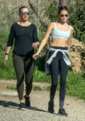 Kaia Gerber shows off her slender figure in crop top and leggings while out on a hike with a friend in Malibu, California