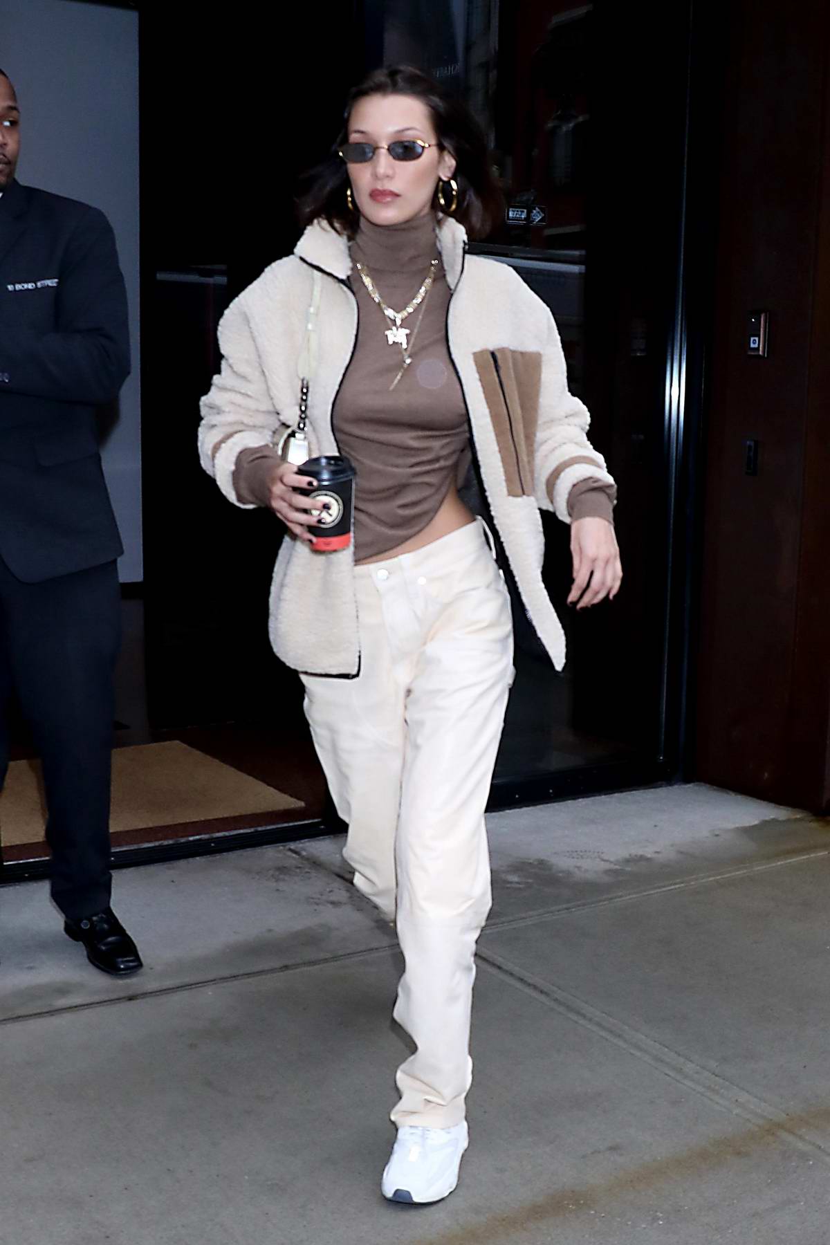 bella hadid looks trendy in a jacket over her brown top and khakis ...
