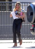 Hilary Duff wears a multi-colored striped top and leather pants while out for a meeting in Los Angeles