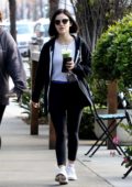 Lucy Hale grabs a green smoothie while out with a friend after her workout session in Los Angeles