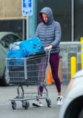 Charlize Theron looks comfy in a puffer jacket and leggings while shopping at Whole Foods on a rainy day in West Hollywood, California