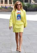 Amanda Holden seen wearing a yellow blazer and skirt with NHS top while leaving Global Studio in London, UK