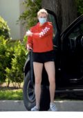 Ireland Baldwin rocks a red hoodie and black shorts while picking up some beverages in Los Angeles