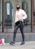 Nicole Murphy wears protective mask and gloves as she takes her dogs out for a stroll in Beverly Hills, California