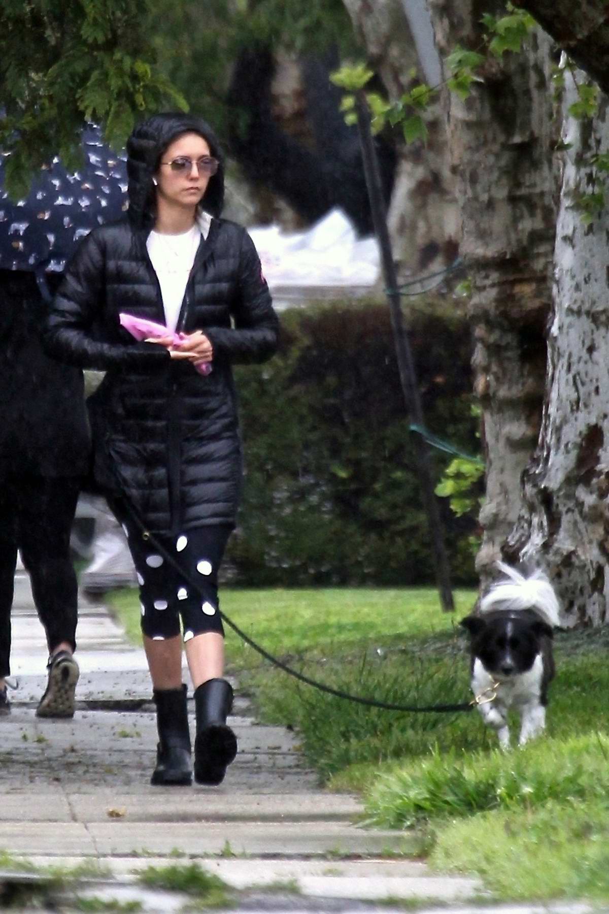 Noomi Rapace sports Gucci hoodie and Burberry check leggings while