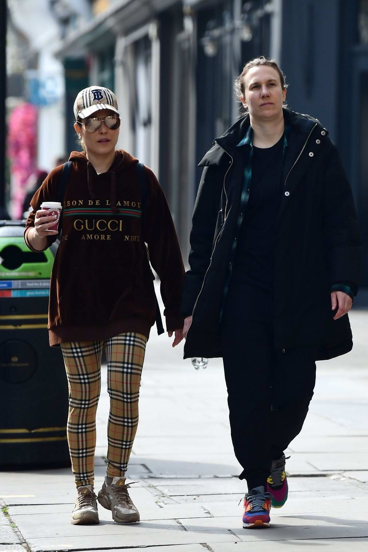 Noomi Rapace sports Gucci hoodie and Burberry check leggings while