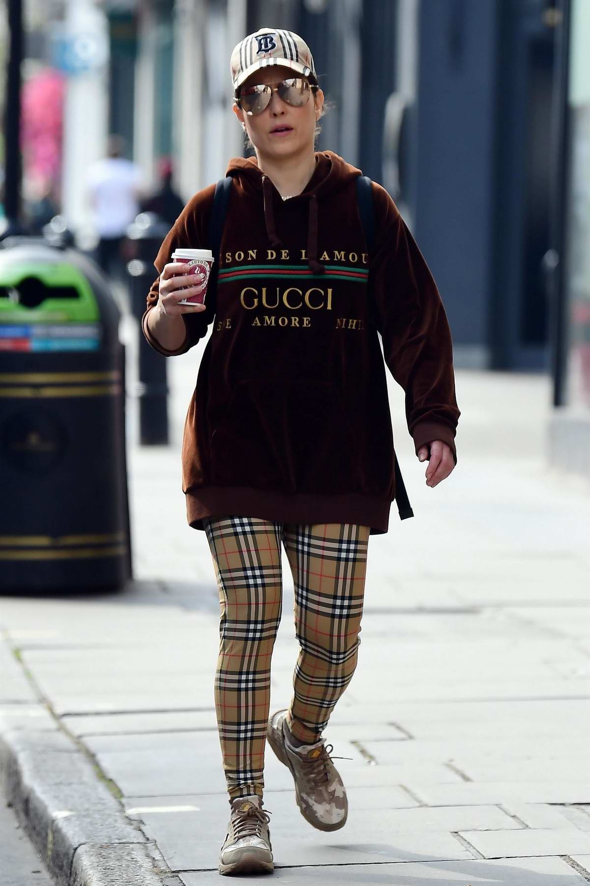 noomi rapace sports gucci hoodie and burberry check leggings while
