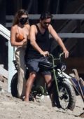 Sofia Richie and Scott Disick enjoy a motorbike ride on the beach in Malibu, California