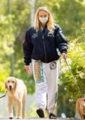 Sophie Turner shows her growing baby bump while out walking her dogs with Joe Jonas in Los Angeles