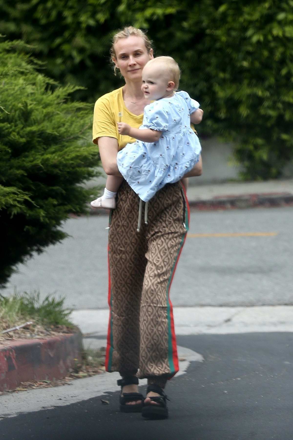 Diane Kruger takes her daughter out for some fresh air around the  neighborhood in Los Angeles