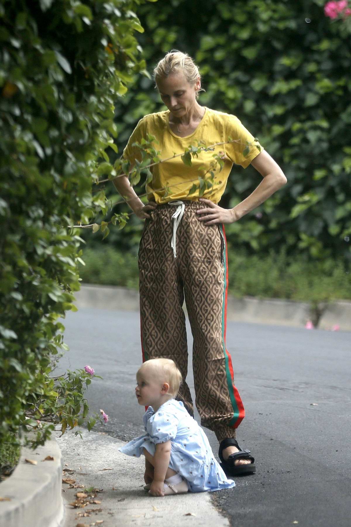 Diane Kruger beams at her daughter Nova, four, after she gives money to a  homeless person while out and about in Manhattan