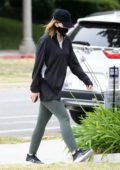 Katherine Schwarzenegger wears a face mask with an oversized shirt and  leggings for an afternoon stroll