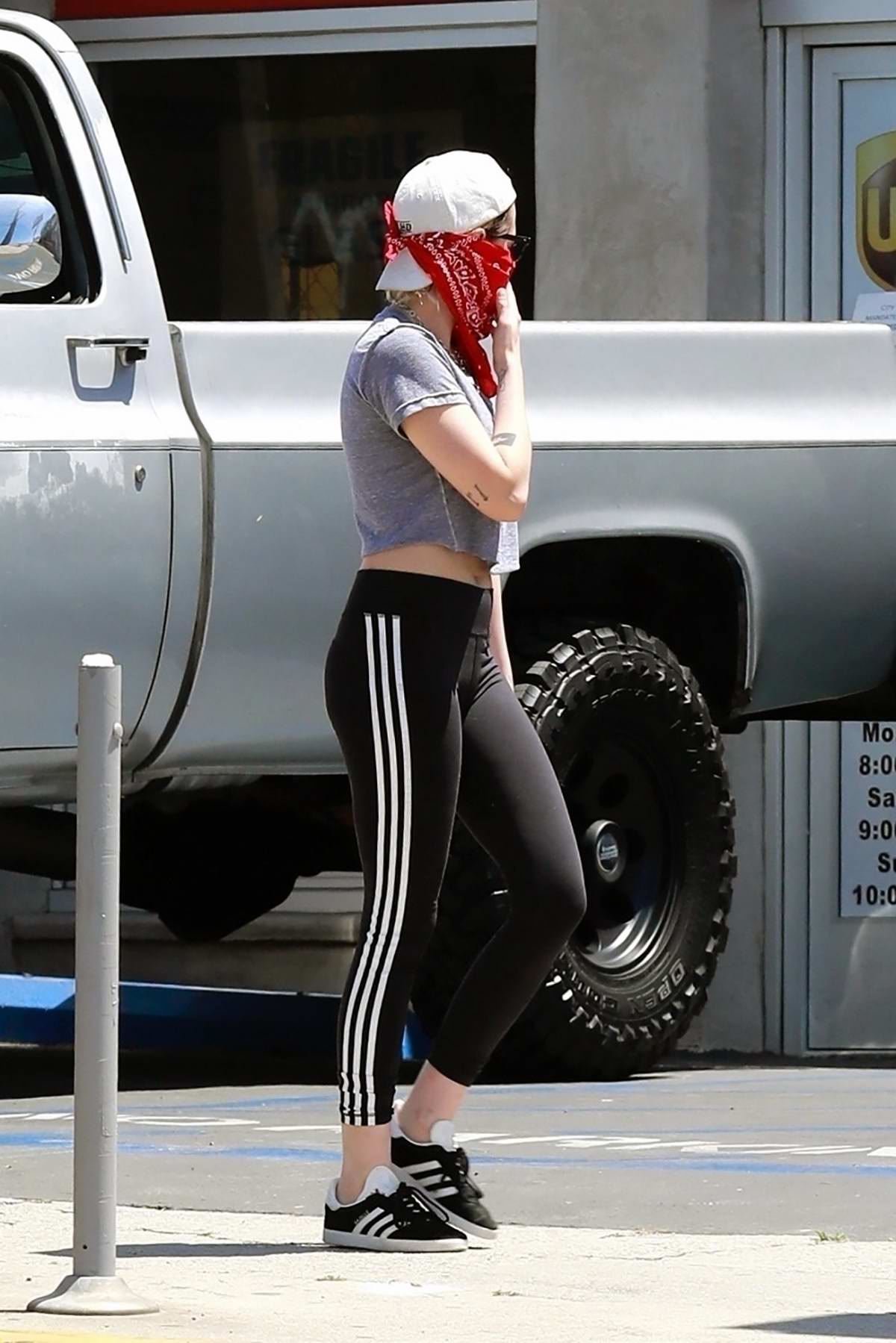 Kristen Stewart sports a grey top with black Adidas leggings as