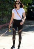 Lucy Hale looks great in a white top and black leggings while walking her pup in Los Angeles