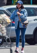 Lucy Hale wears a denim jacket and blue leggings as she goes grocery shopping in Los Angeles