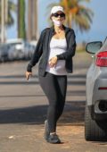 Katherine Schwarzenegger caresses her baby bump while out for a stroll in Venice beach, California