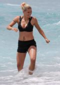 Michelle Hunziker shows off her fit body as she hits the beach with friends in Varigotti, Italy