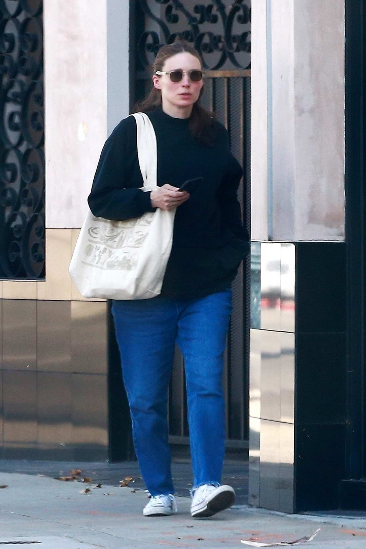 rooney mara covers up her baby bump in an oversized sweatshirt as she