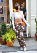 Bella Hadid displays her toned midriff in a crop top while visiting Aimé Leon Dore store in New York City