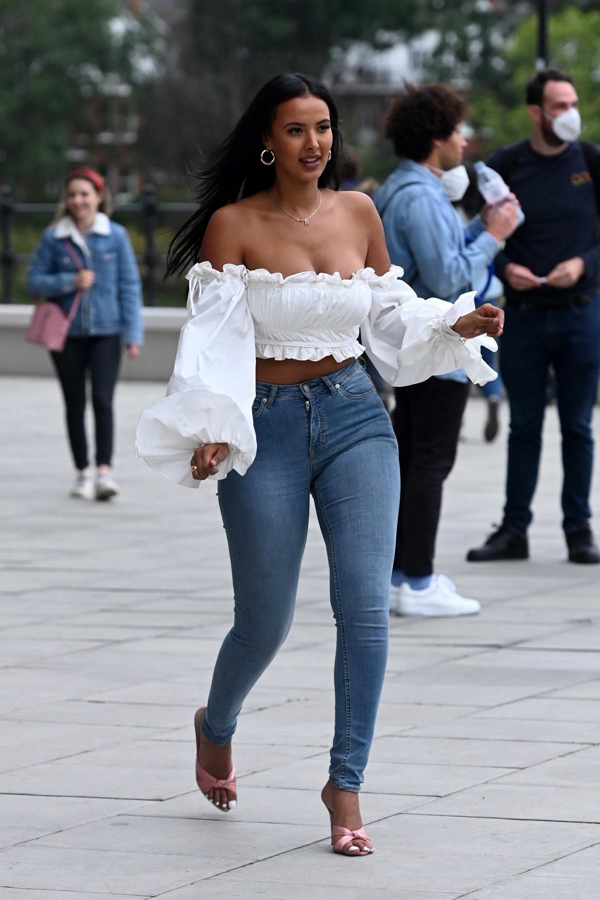 Maya Jama looks stunning in a white crop top and tight jeans as