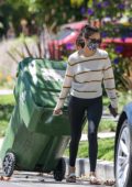 Nina Dobrev seen outside her home taking garbage bins inside before heading out on her Tesla, West Hollywood, California