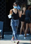 Eiza Gonzalez sports black tank top and blue joggers while grabbing an iced coffee from Alfred's in West Hollywood, California