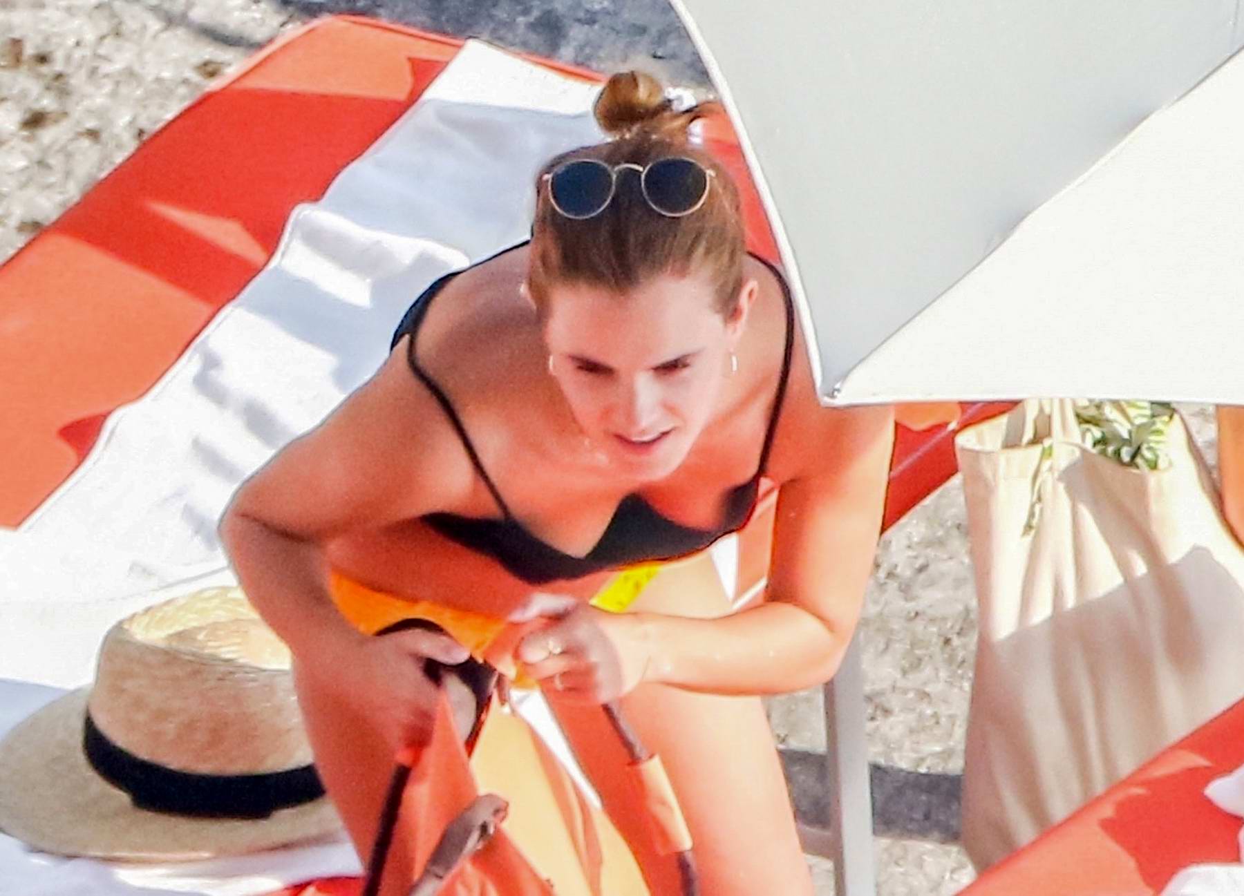 Emma Watson Spotted In A Black Crop Top And Yellow Bikini Bottoms While 
