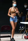 Hailey Bieber looks trendy in a crop top and denim shorts while visiting Justin Bieber during a photoshoot at a studio in Los Angeles