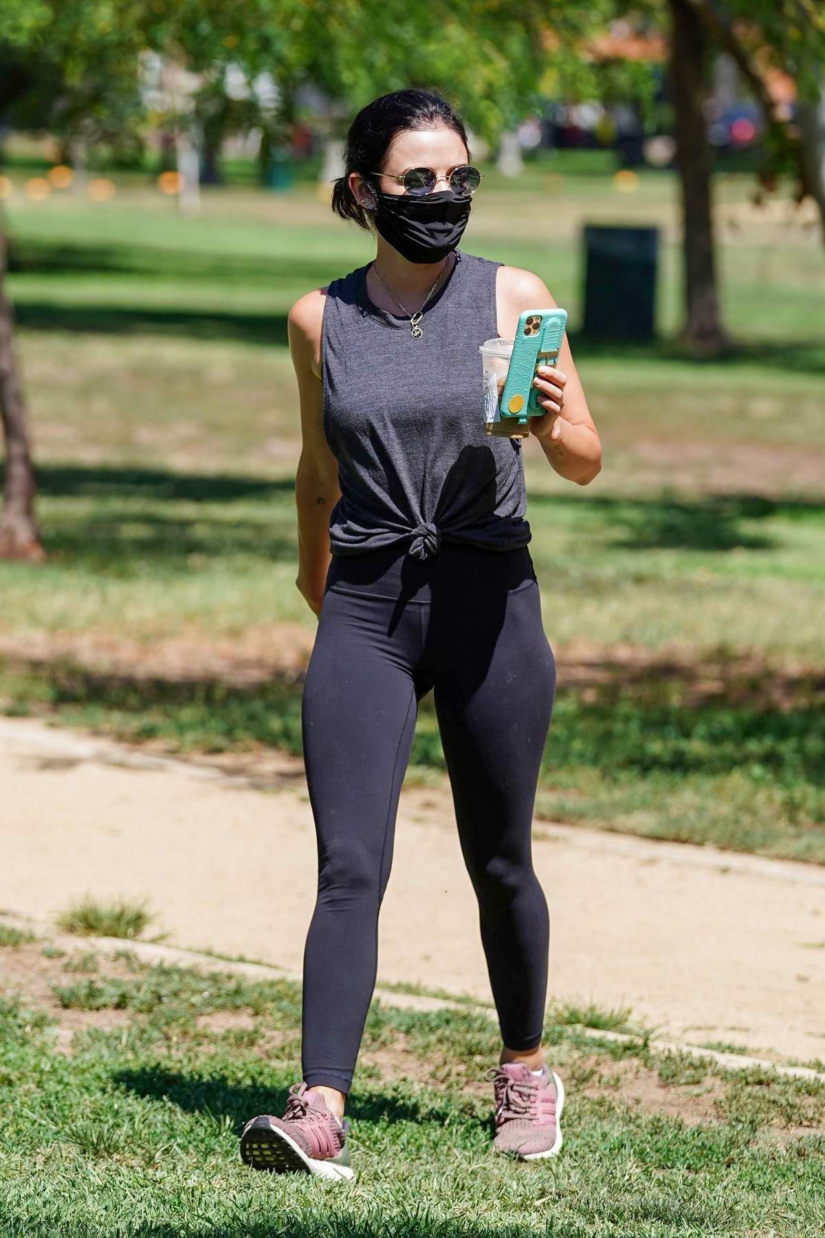 Olivia Wilde looks sporty in a black hoodie and leggings as she