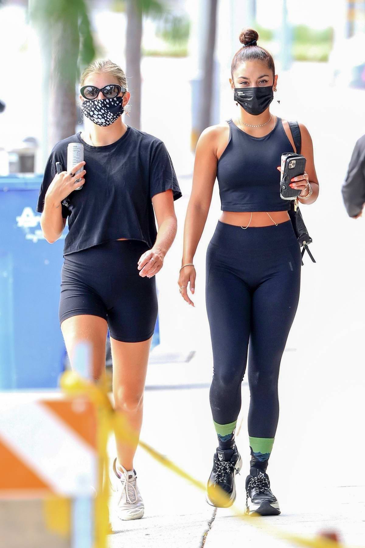 Vanessa Hudgens shows off her fit figure in black workout top and