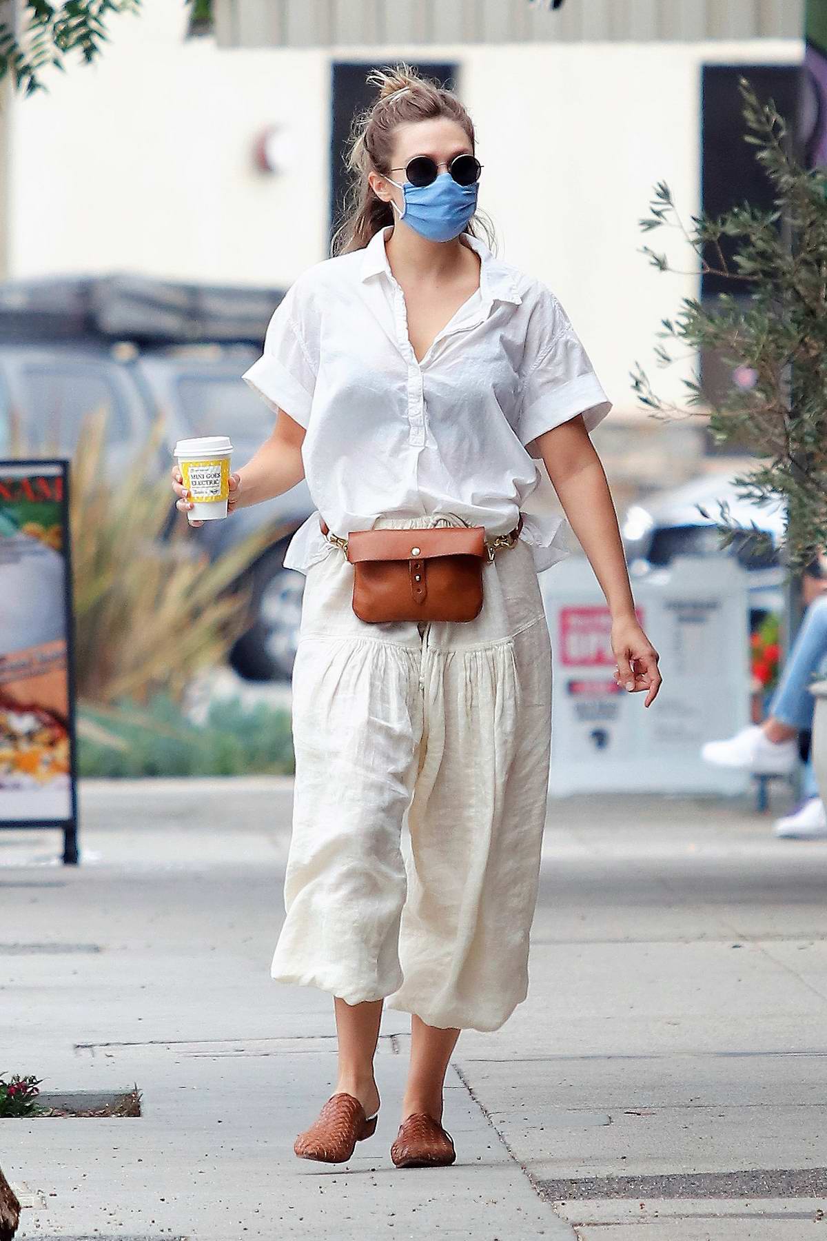 Elizabeth Olsen wears an all-white ensemble while making a coffee run