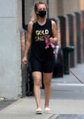 Kaley Cuoco takes her dog out for a walk wearing black tank top and bike shorts in New York City