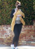 Katherine Schwarzenegger cradles one-month-old baby girl Lyla during a stroll in Brentwood, California