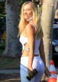 Alexis Ren flaunts her curves in white crop top and tight-fitting pants  during a juice