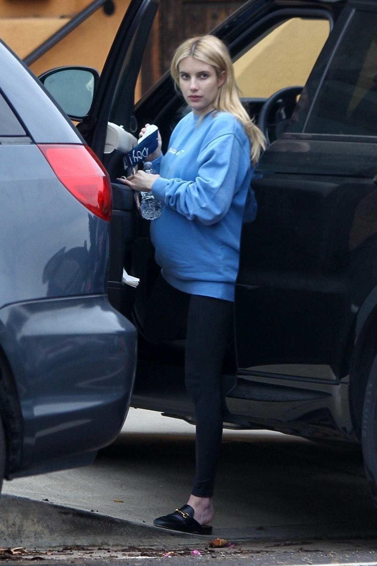 Emma Roberts wears a sweatshirt and leggings during her shopping