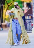Hailey Bieber shows off her style in a fuzzy yellow coat while out on a coffee run in New York