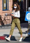 Eiza Gonzalez flashes her toned midriff in a cropped cardigan while making a coffee run in West Hollywood, California