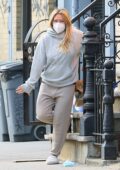 Hilary Duff looks cozy in her sweats as she steps out to pick up delivered food in New York City