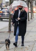 Lili Reinhart carries a clear umbrella as she takes her dog out for a walk in Vancouver, Canada