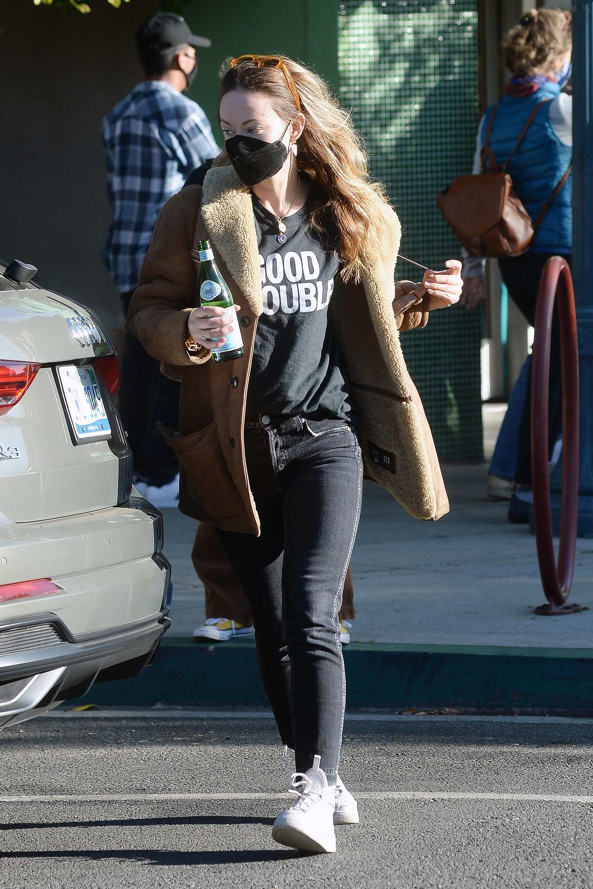 Jennifer lopez seen wearing a black hoodie and black leggings with a pair  of neon green