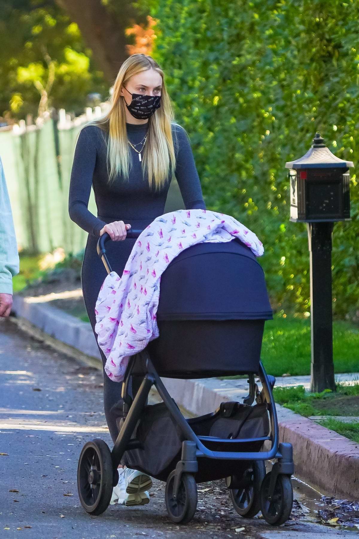 Sophie Turner gazes lovingly at her three-month-old baby girl Willa on a  morning walk
