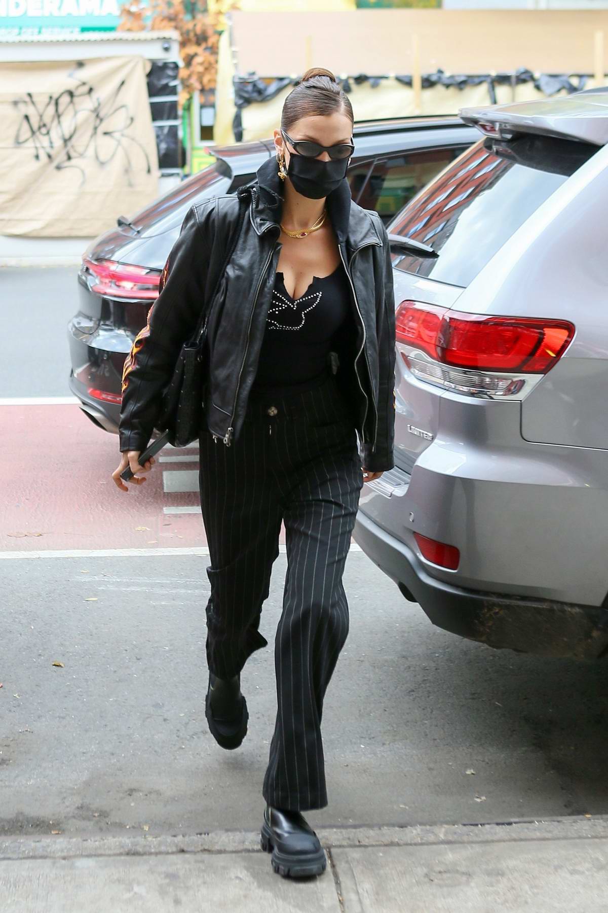 Model Bella Hadid is seen wearing Chanel bag, checkered scarf
