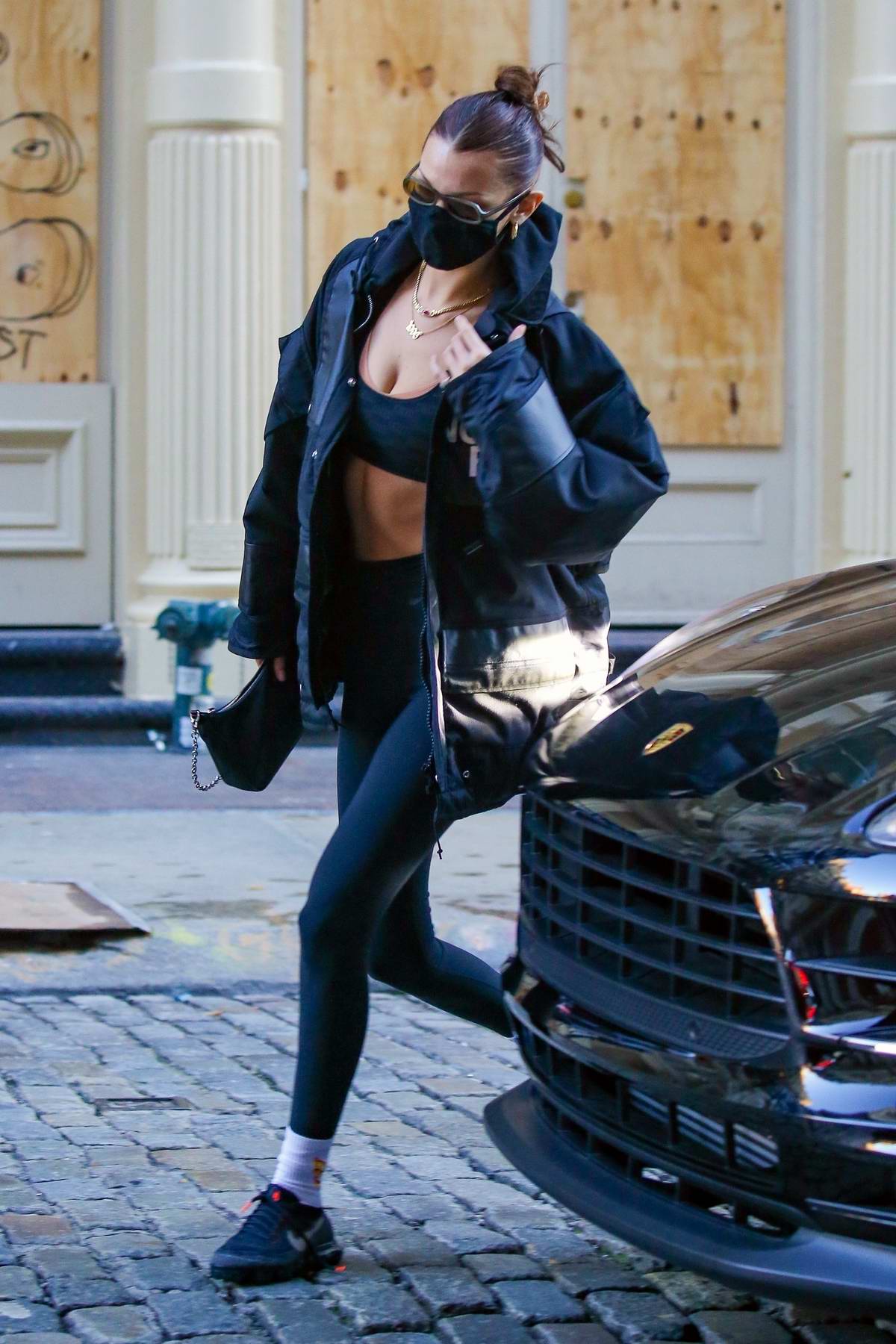 Bella Hadid rocks a North Face jacket with a sports bra and leggings as she  heads