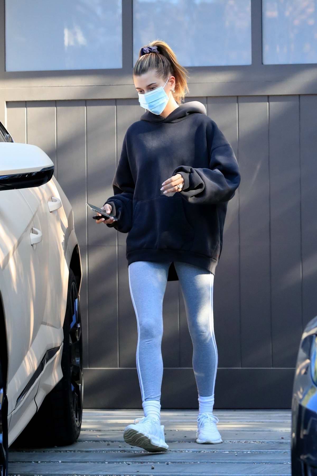 Hailey Bieber sports a black hoodie and grey leggings as she attends her  yoga class before